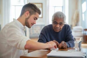 Investing in assisted living also helps improve the lives of older adults, like this senior and the health aide.